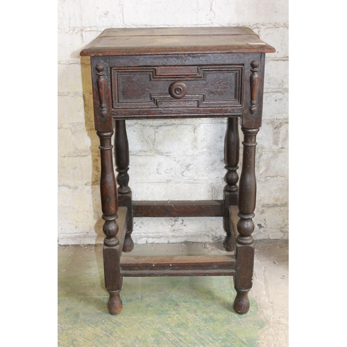 591 - Carved oak bedside table with frieze drawer.