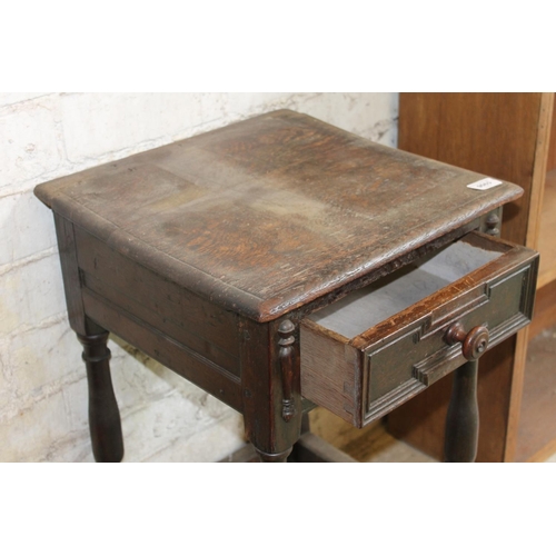 591 - Carved oak bedside table with frieze drawer.