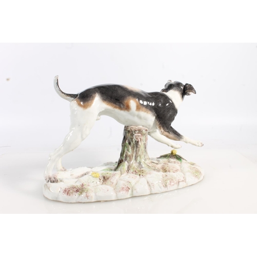 435 - Two 19th century Continental porcelain modesl of dogs, modelled bearing it teeth (af broken leg, the... 