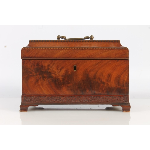 447 - 19th century flame mahogany tea caddy of casket form with fret carved band, raised on squat ogee bra... 