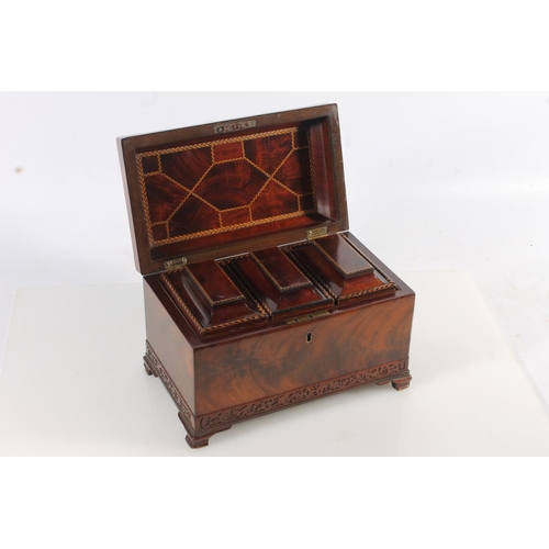 447 - 19th century flame mahogany tea caddy of casket form with fret carved band, raised on squat ogee bra... 