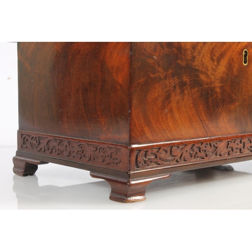 447 - 19th century flame mahogany tea caddy of casket form with fret carved band, raised on squat ogee bra... 