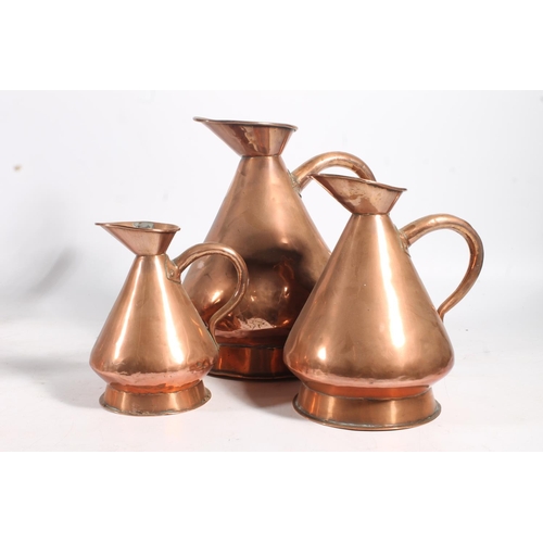 451 - Copper metal ware to include mulling cone, kettle and a graduated set of three harvest measure jugs.... 