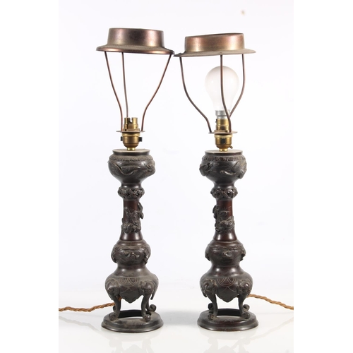 479 - Pair of Oriental bronze table lamps of incense burner form decorated with relief flowers and foliage... 