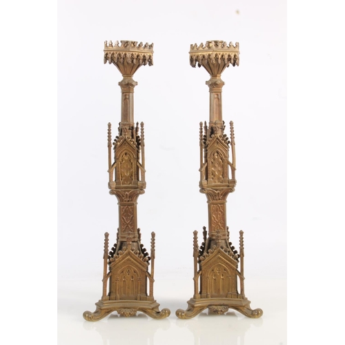 487 - Pair of gilded brass candlesticks in the Gothic ecclesiastical Puginesque style, 43cm tall.