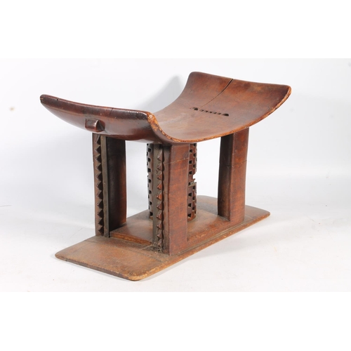 545 - Antique hardwood stool in the form of an African Ashanti neck rest, 47cm wide.