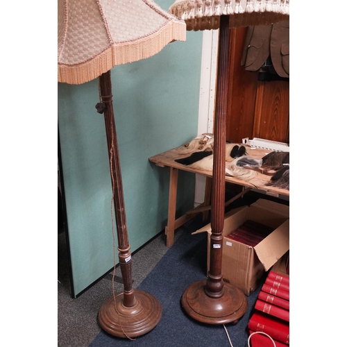 535 - Two oak standard lamps one with reeded and one with fluted column. (2)