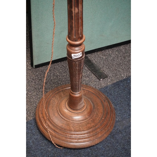 535 - Two oak standard lamps one with reeded and one with fluted column. (2)