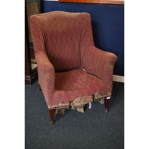 581 - 19th century wing chair raised on mahogany square tapering supports capped by castors.