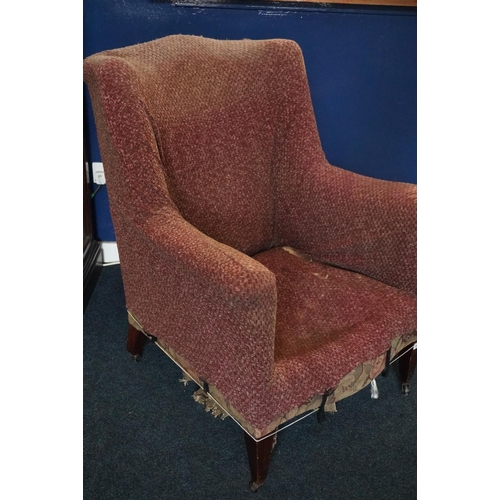 581 - 19th century wing chair raised on mahogany square tapering supports capped by castors.