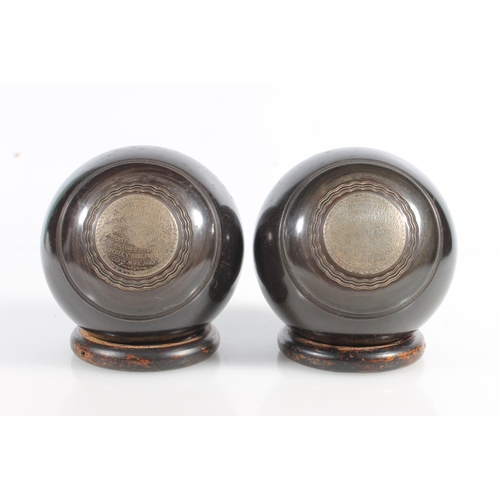 163 - Pair of lawn bowls with silver plaques inscribed 