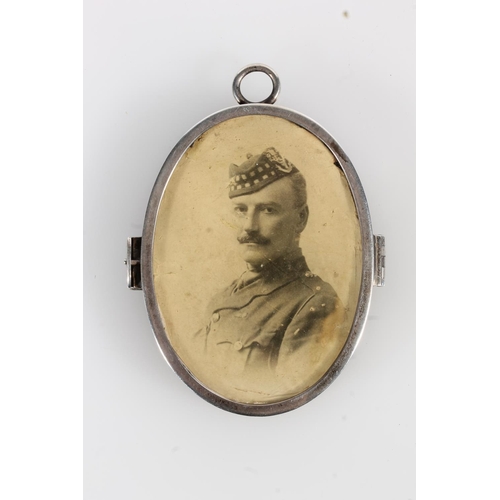 165 - Asprey and Co of London, an oval silver photograph locket, London 1914, 8cm tall.