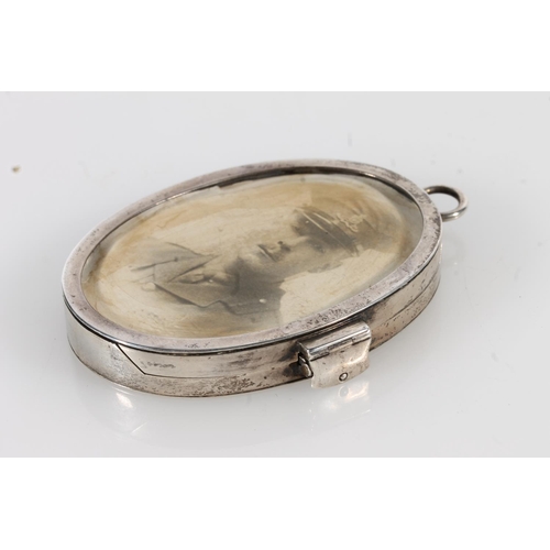 165 - Asprey and Co of London, an oval silver photograph locket, London 1914, 8cm tall.