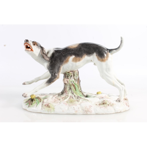 435 - Two 19th century Continental porcelain modesl of dogs, modelled bearing it teeth (af broken leg, the... 