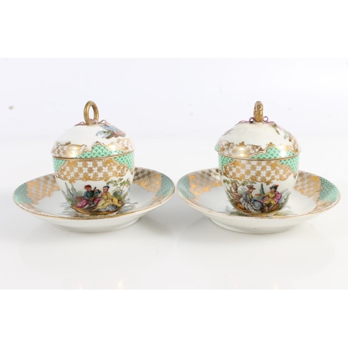 501 - Pair of Continental porcelain chocolate cups and covers on stands having green and gilt borders and ... 