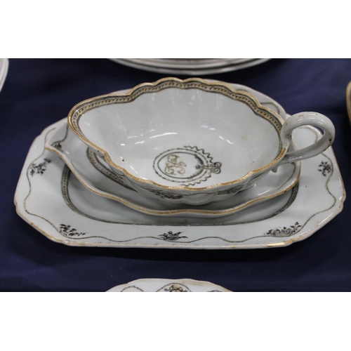 503 - 19th century porcelain part dinner set decorated with black and gilt design, having central cartouch... 