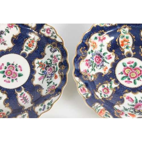 506 - Pair of antique Worcester porcelain blue scale ground wavy edge dishes decorated with hand painted f... 