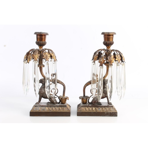 511 - Pair of gilt metal candlesticks with bronzed greyhound supporters, having faceted glass drops, 23cm ... 