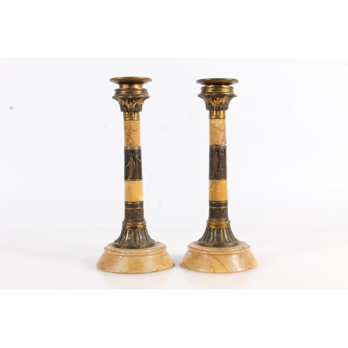 513 - Pair of Egyptian Revival gilt metal and marble candlesticks, 19cm tall.