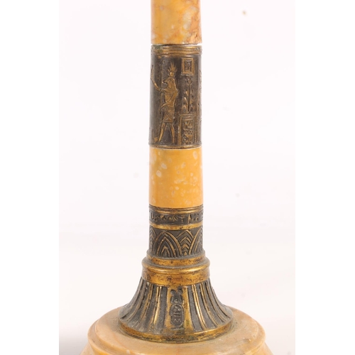 513 - Pair of Egyptian Revival gilt metal and marble candlesticks, 19cm tall.