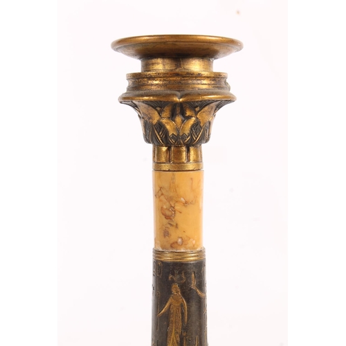 513 - Pair of Egyptian Revival gilt metal and marble candlesticks, 19cm tall.