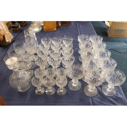 516 - Mixed suite of etched glassware with fruiting grape vine decoration comprising decanters, jug, rumme... 