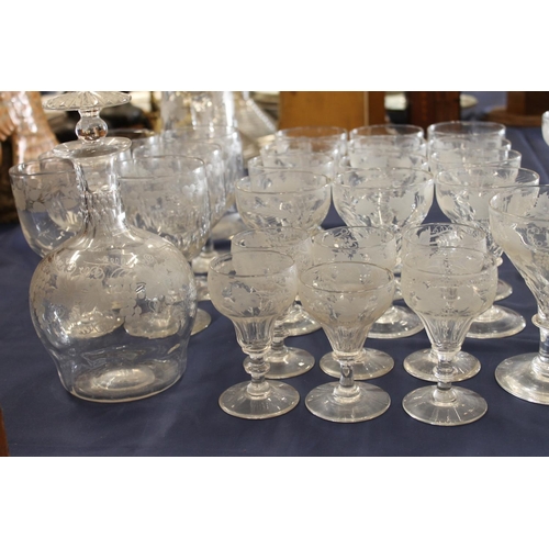 516 - Mixed suite of etched glassware with fruiting grape vine decoration comprising decanters, jug, rumme... 