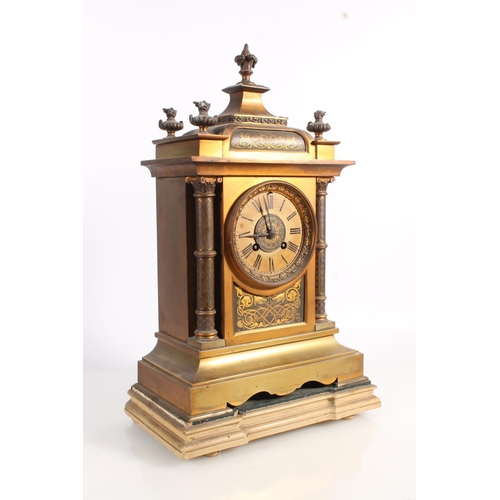 517 - Antique French gilt metal mantle clock decorated with damascene work to the panels and the columns, ... 