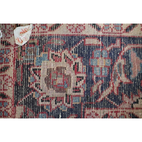 594 - Red ground Persian Keshan rug, the central field surrounded by blue ground border. 195cm x 123cm.