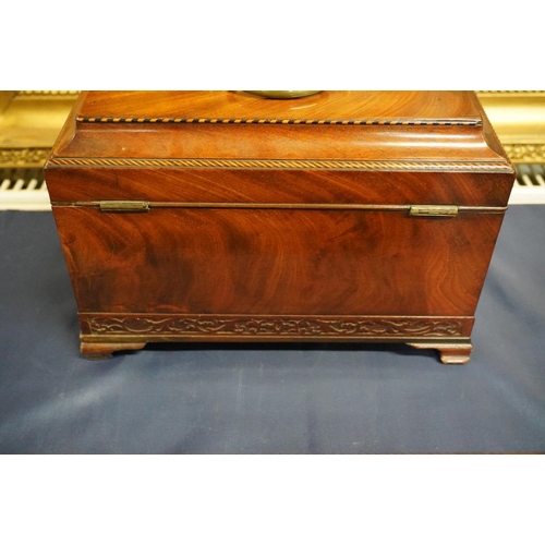 447 - 19th century flame mahogany tea caddy of casket form with fret carved band, raised on squat ogee bra... 