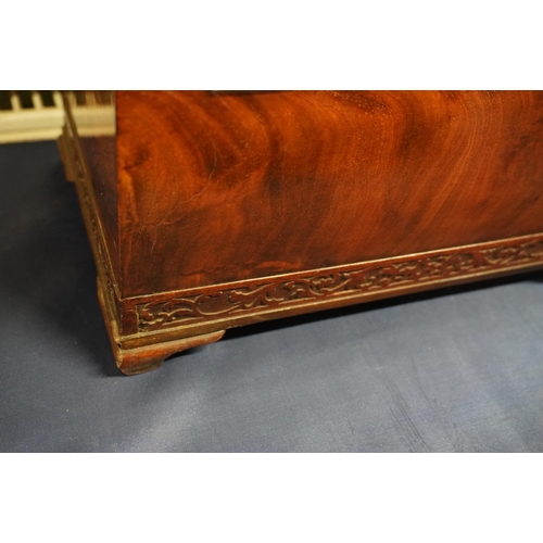 447 - 19th century flame mahogany tea caddy of casket form with fret carved band, raised on squat ogee bra... 