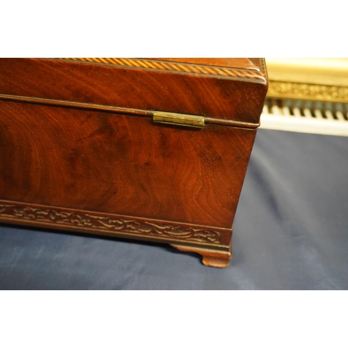 447 - 19th century flame mahogany tea caddy of casket form with fret carved band, raised on squat ogee bra... 