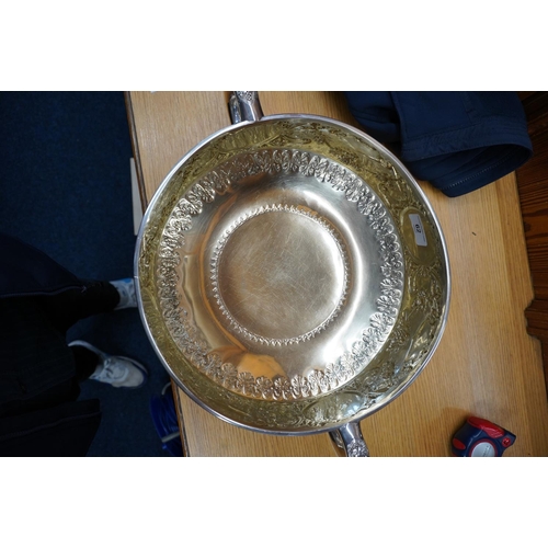 62 - Victorian silver twin handled punch bowl with gilded interior and embossed ornate designs of garland... 