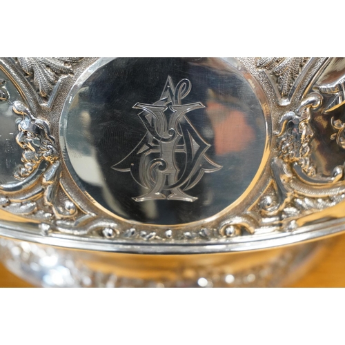 62 - Victorian silver twin handled punch bowl with gilded interior and embossed ornate designs of garland... 