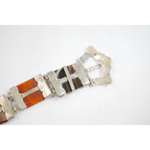 191 - Scottish pebble set white metal bracelet of buckle and strap form set with banded agate, probably si... 