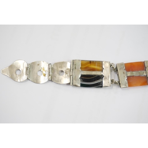 191 - Scottish pebble set white metal bracelet of buckle and strap form set with banded agate, probably si... 