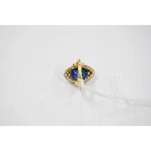 176 - Unmarked yellow metal ring, the large faceted oval sapphire surround by round cut diamonds in a nave... 