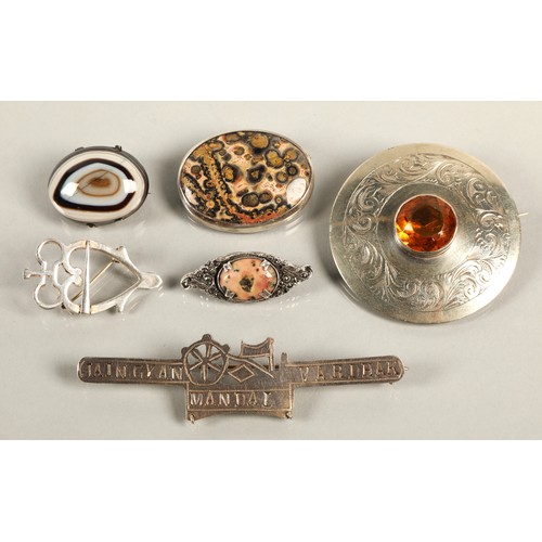 57 - Assorted brooches silver and gem set to include an orange gem set plaid brooch, a silver luckenbooth... 