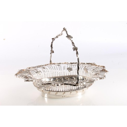 61 - George II silver swing handled basket of superb quality, of oval form having fruiting grape vine dec... 