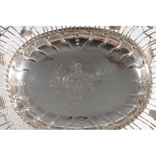 61 - George II silver swing handled basket of superb quality, of oval form having fruiting grape vine dec... 