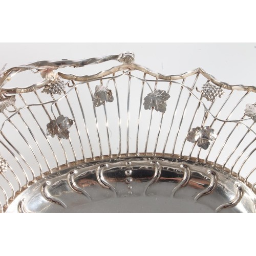 61 - George II silver swing handled basket of superb quality, of oval form having fruiting grape vine dec... 