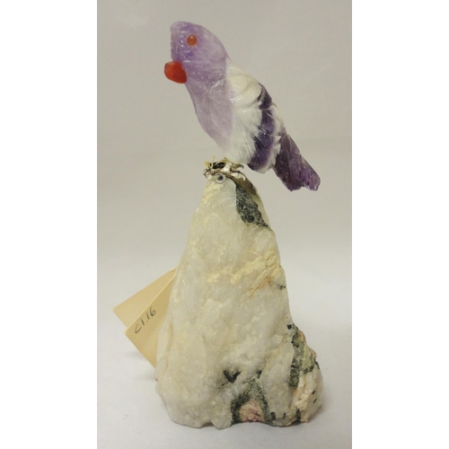 386 - Peter Müller Brazilian stone carved mineral specimen modelled as a bird perched on a rock, the beak ... 