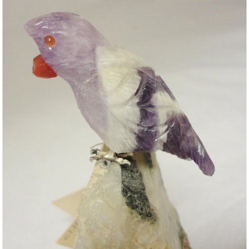 386 - Peter Müller Brazilian stone carved mineral specimen modelled as a bird perched on a rock, the beak ... 