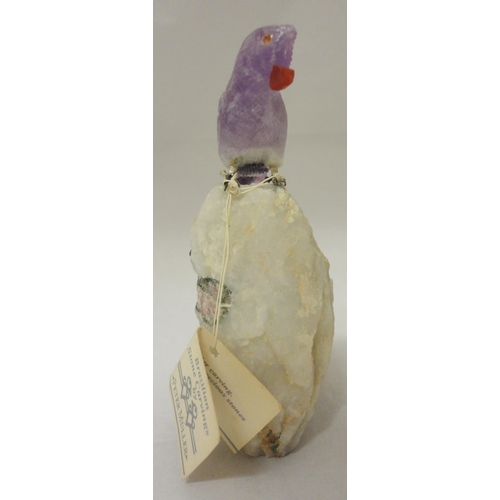 386 - Peter Müller Brazilian stone carved mineral specimen modelled as a bird perched on a rock, the beak ... 