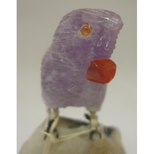 386 - Peter Müller Brazilian stone carved mineral specimen modelled as a bird perched on a rock, the beak ... 