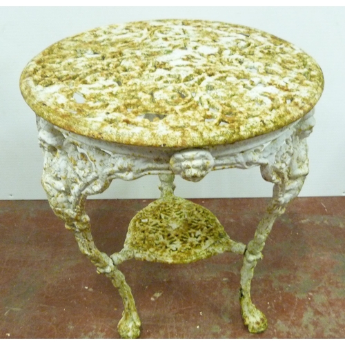 521 - In the Manner of CoalbrookdaleHeavy painted iron garden suite comprising a circular table decorated ... 