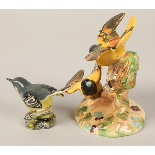 23 - Two Beswick bird ornaments to include wagtail and a pair of Baltimore Orioles figurine model 92613cm... 