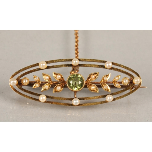 53 - 15ct gold Edwardian brooch set with seed pearls and  peridot, 4g