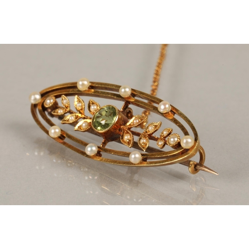 53 - 15ct gold Edwardian brooch set with seed pearls and  peridot, 4g