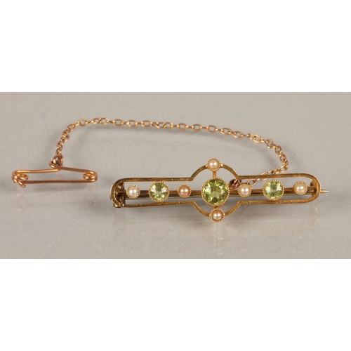 55 - Edwardian yellow metal brooch set with seed pearls and three peridot stones, 3.3g